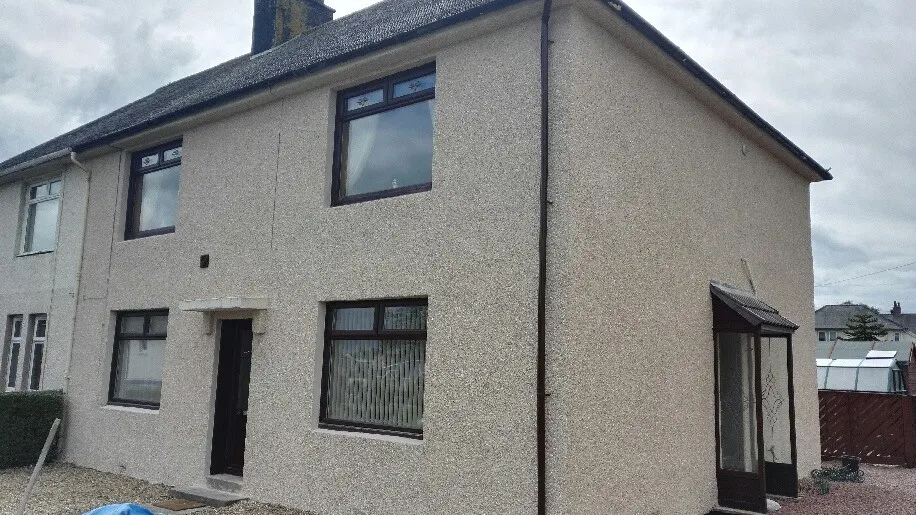 Semi-detached house with a roughcast exterior finish